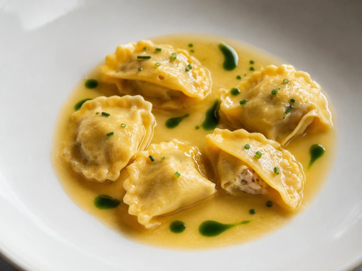 Blue crab agnolotti in golden crab broth